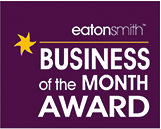 Light-up letters and vintage illuminated lamps creating an awards-night display at the Eaton Smith Business of the Month Awards.